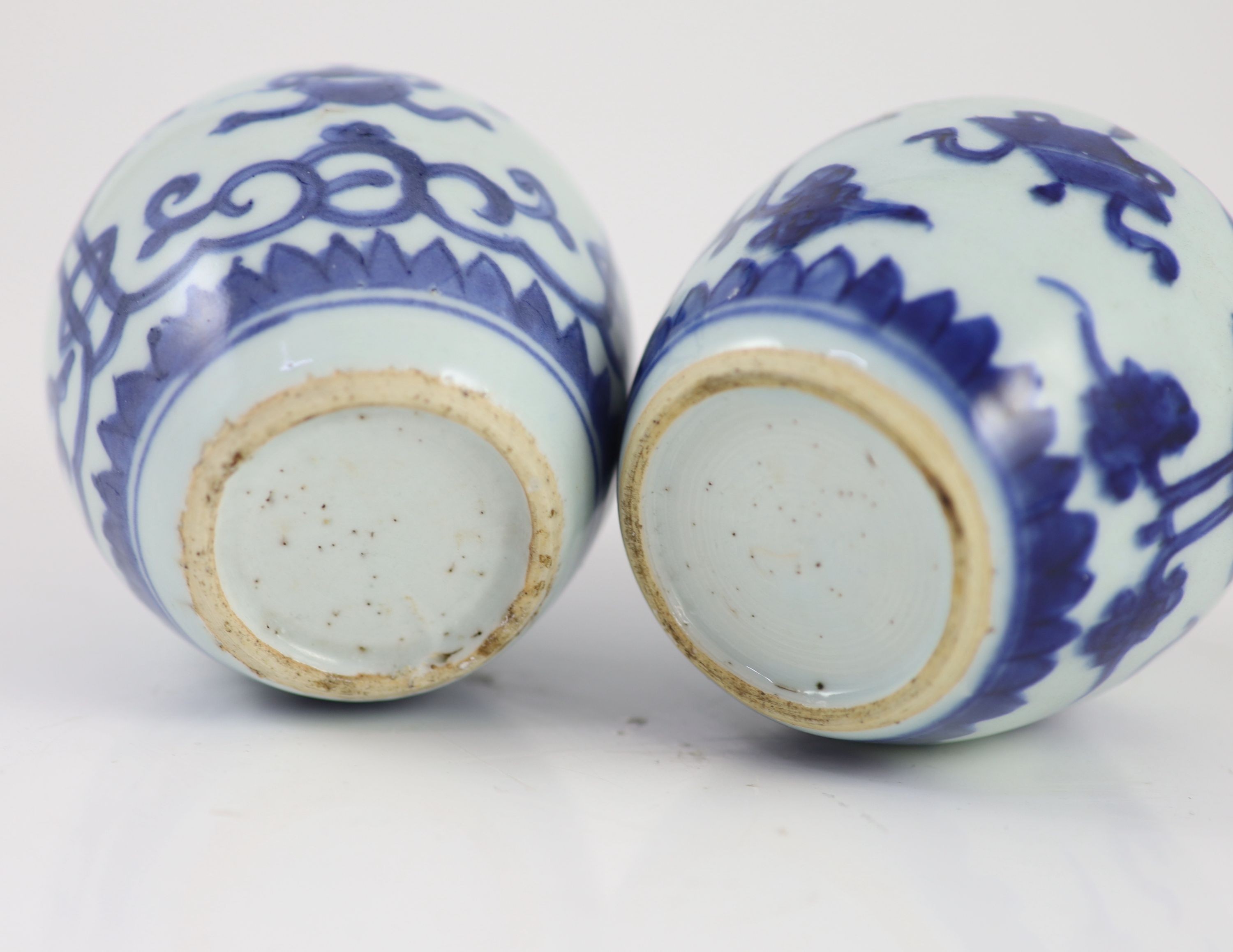 A near pair of Chinese blue and white ovoid jars, Kangxi period, 10 cm high, wood covers